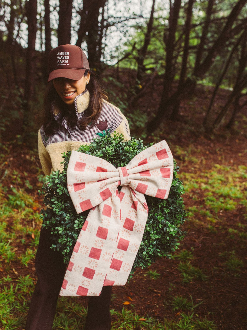 <p>"There are certain things I never want to rush about the holidays. The drive to get the tree and wreath. The smell of pine. Cold hands and muddy boots. Your favorite people in the car and the music on full blast, taking the long way home. That was the feeling behind these bows. We took Coperta Check, one of my favorite patterns from our new sister brand, The Keeping House, and turned it into something wonderfully festive. Both the fabric and bows are proudly made here in the Carolinas.
Here’s to the traditions we keep, the ones we make up as we go, and always taking the scenic route.”